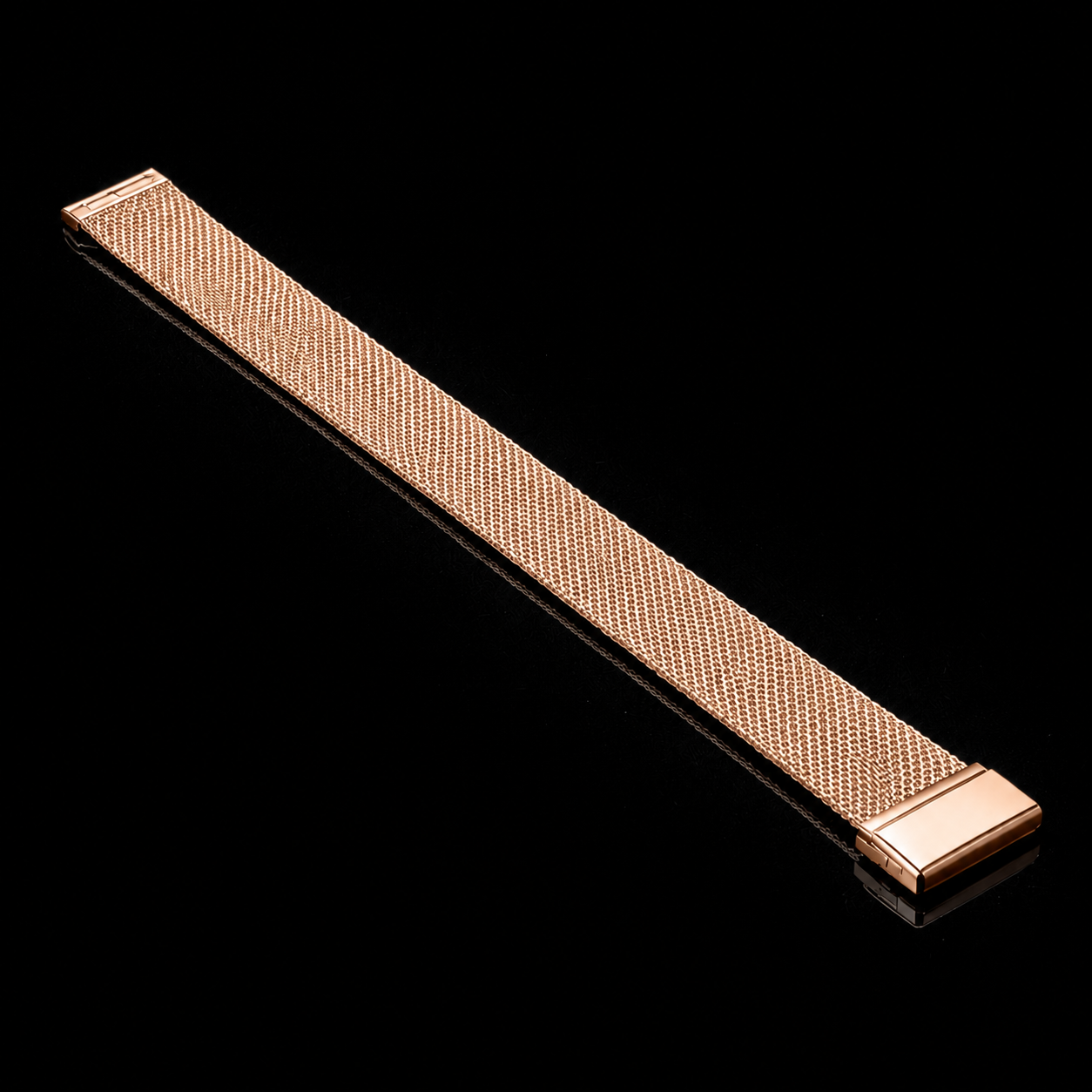 Full-length rose gold NOVACCHI Milanese Mesh Band laid diagonally on a black reflective background